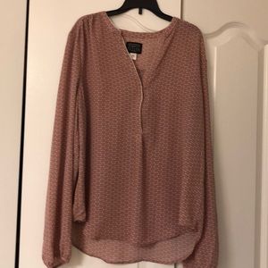 Long sleeve pale pink and white blouse.